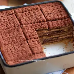 Mattonella al caffè con oro Saiwa, stratificata e spolverata di cacao, un dolce goloso pronto da gustare.