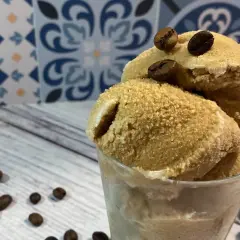 Deliziosa granita di caffè fatta in casa, servita in un bicchiere con chicchi di caffè tostati.