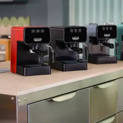 Macchine da caffè Gaggia in vari colori, una rossa, una nera, una grigia e una verde acqua, disposte su un bancone. Speriamo che la macchina caffè Gaggia non esca il caffè, altrimenti la colazione è rovinata!
